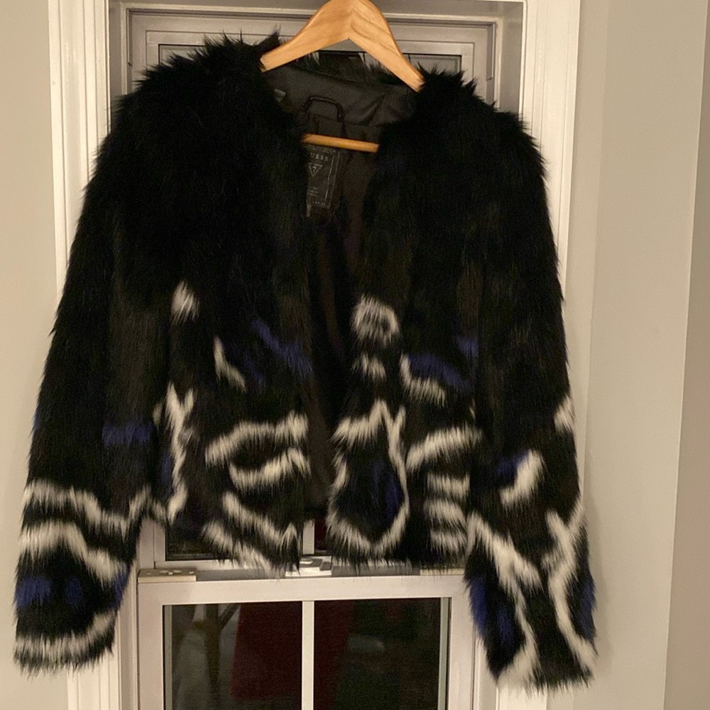 A black, white, and blue faux fur jacket from Guess